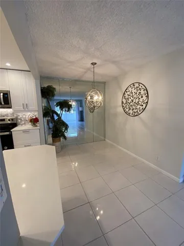 a kitchen with stainless steel appliances a refrigerator sink and cabinets
