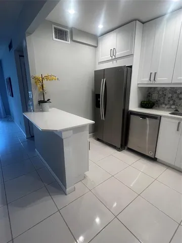 a kitchen with appliances and cabinets