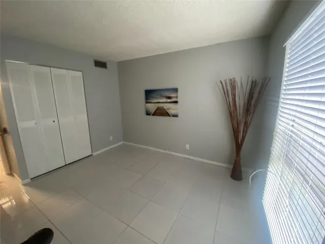 a white bath tub sitting in a room next to a window