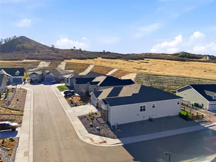 an aerial view of residential building with outdoor space and seating