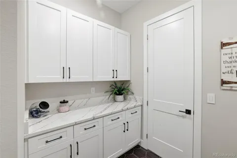 a kitchen with white cabinets and white appliances