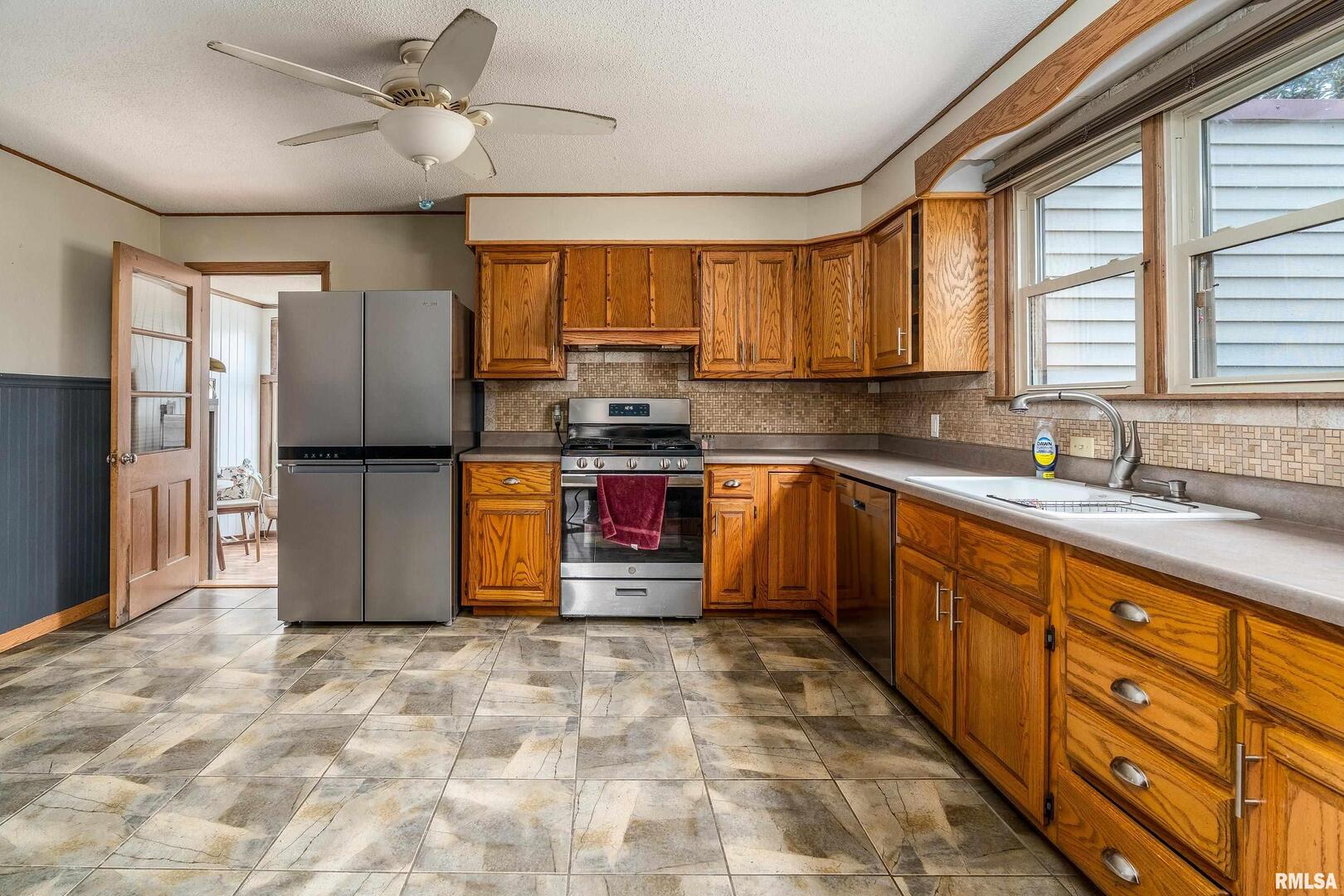 306 South Madison Street Marion, IL 62959 - Photo 11 of 37 a kitchen with stainless steel appliances granite countertop a refrigerator sink and cabinets