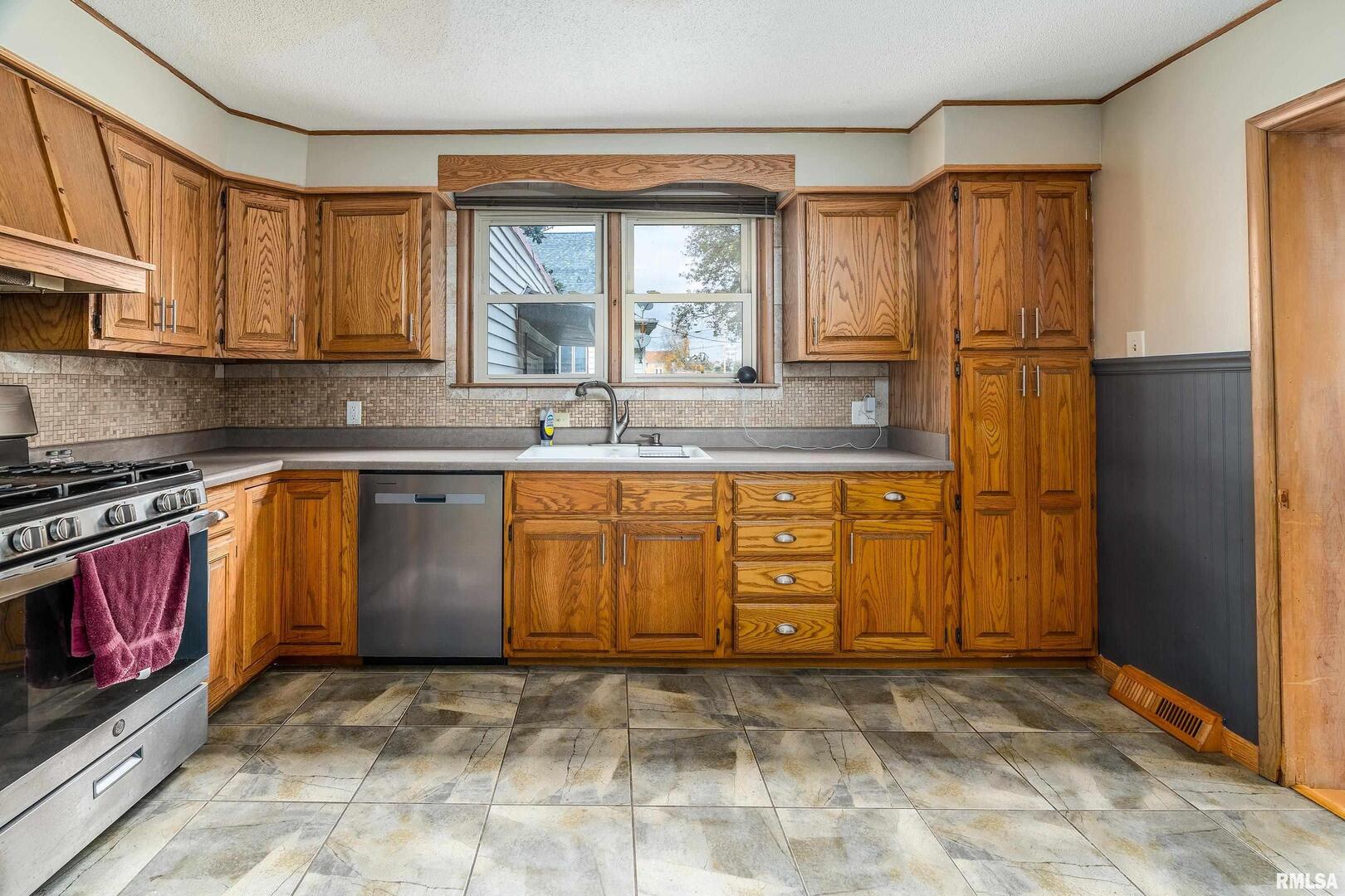 306 South Madison Street Marion, IL 62959 - Photo 13 of 37 a kitchen with stainless steel appliances granite countertop a stove a sink and a refrigerator