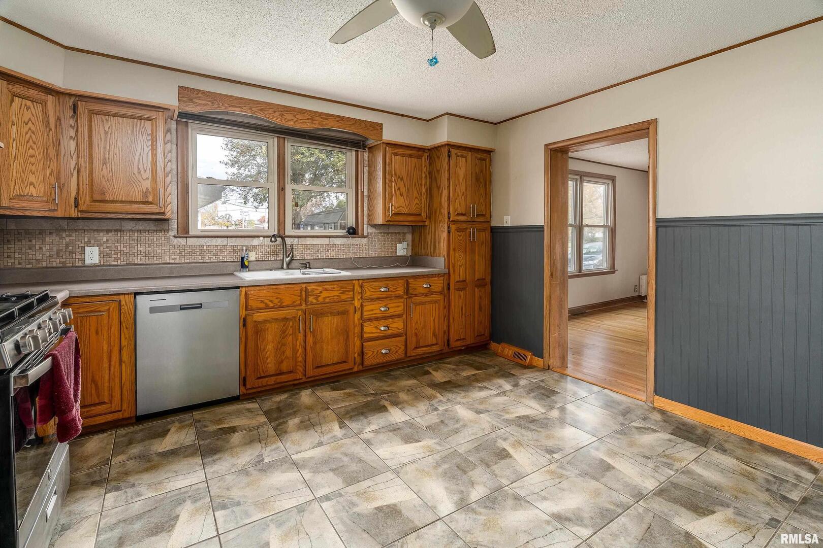 306 South Madison Street Marion, IL 62959 - Photo 14 of 37 a kitchen with stainless steel appliances granite countertop a stove sink and cabinets