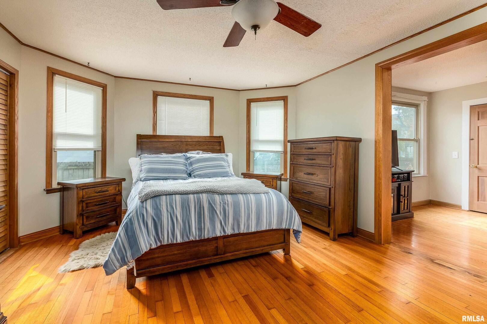 306 South Madison Street Marion, IL 62959 - Photo 15 of 37 a bedroom with a bed and wooden floor