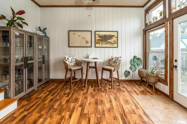 a dining room with furniture and wooden floor