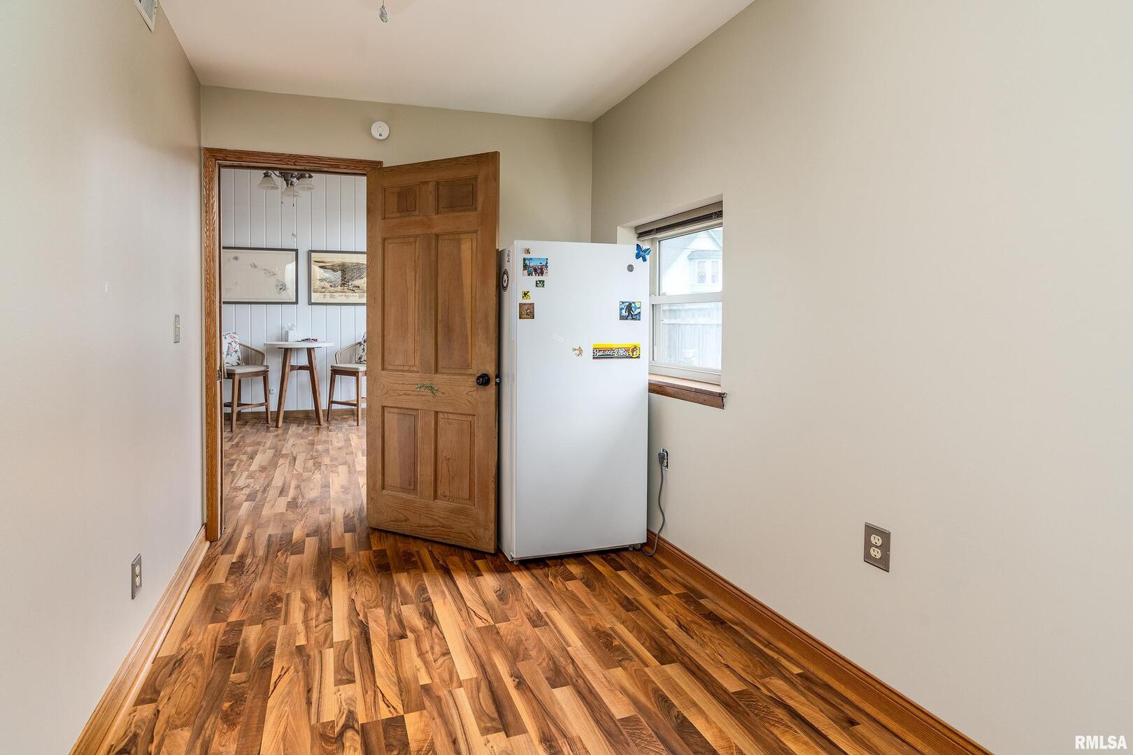 306 South Madison Street Marion, IL 62959 - Photo 29 of 37 a view of a kitchen with wooden floor and a refrigerator