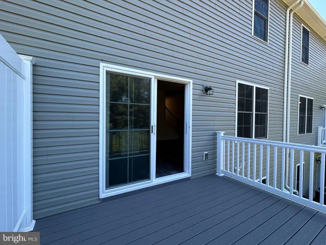 a view of a house with wooden deck