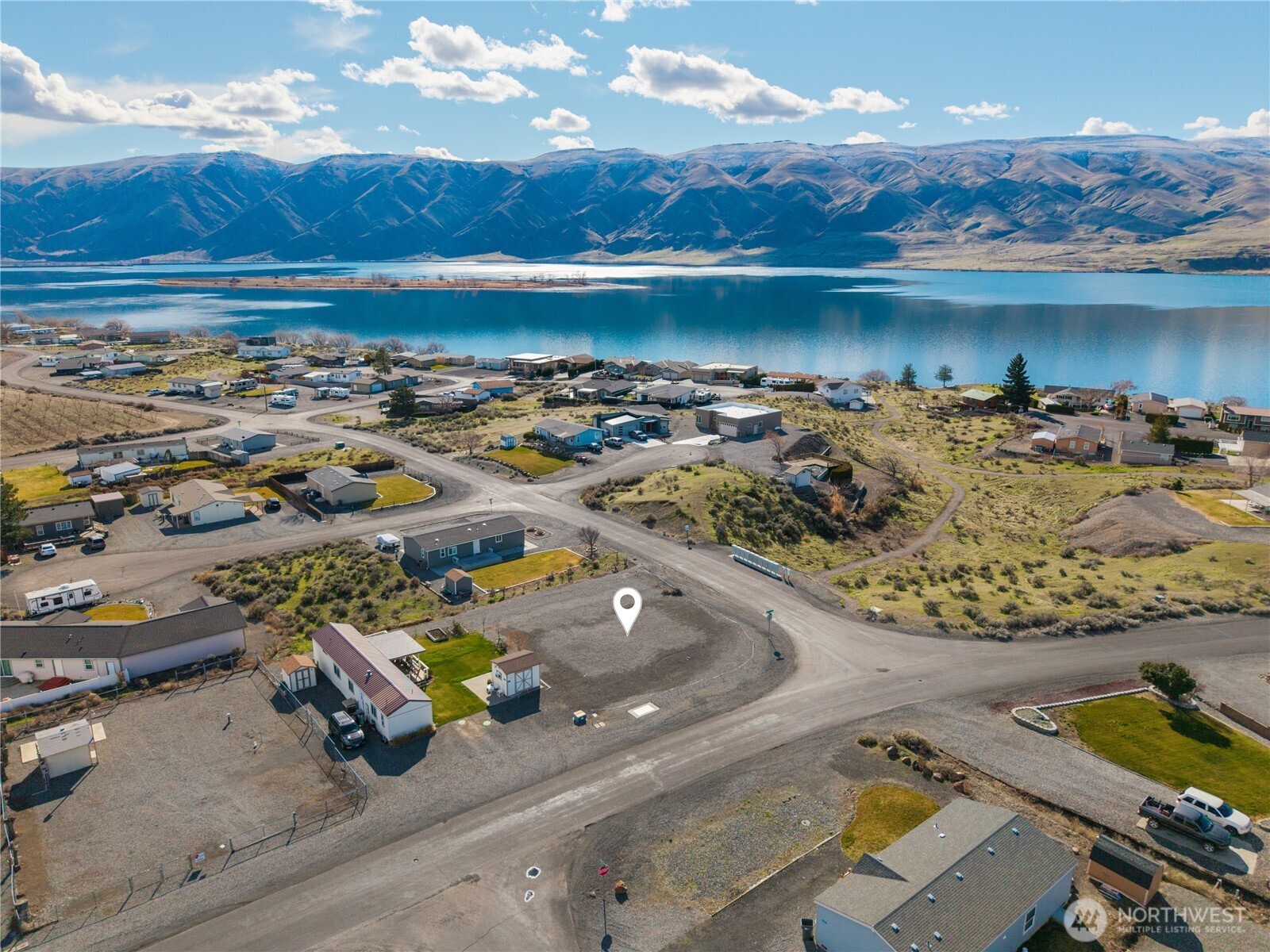 an aerial view of a house with a swimming pool patio and lake view