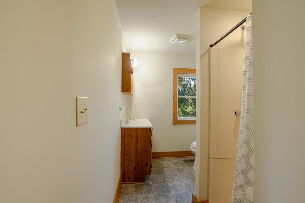 681 Downing Road Stockport, OH 43787 - Photo 21 of 36 bathroom vanity shower and window view
