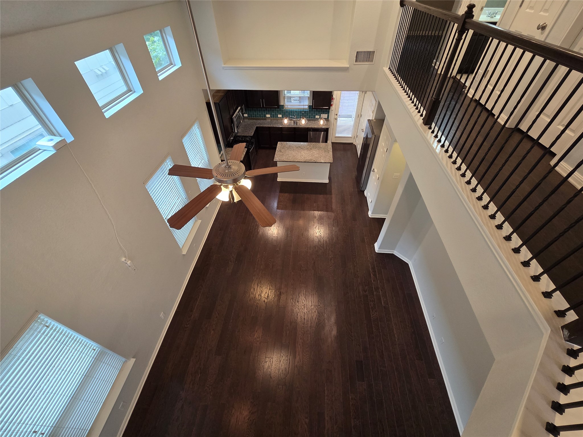7337 Menchaca Road, Unit #22 Austin, TX 78745 - Photo 14 of 25 View of the downstairs living space from upstairs, showing wood finished floors