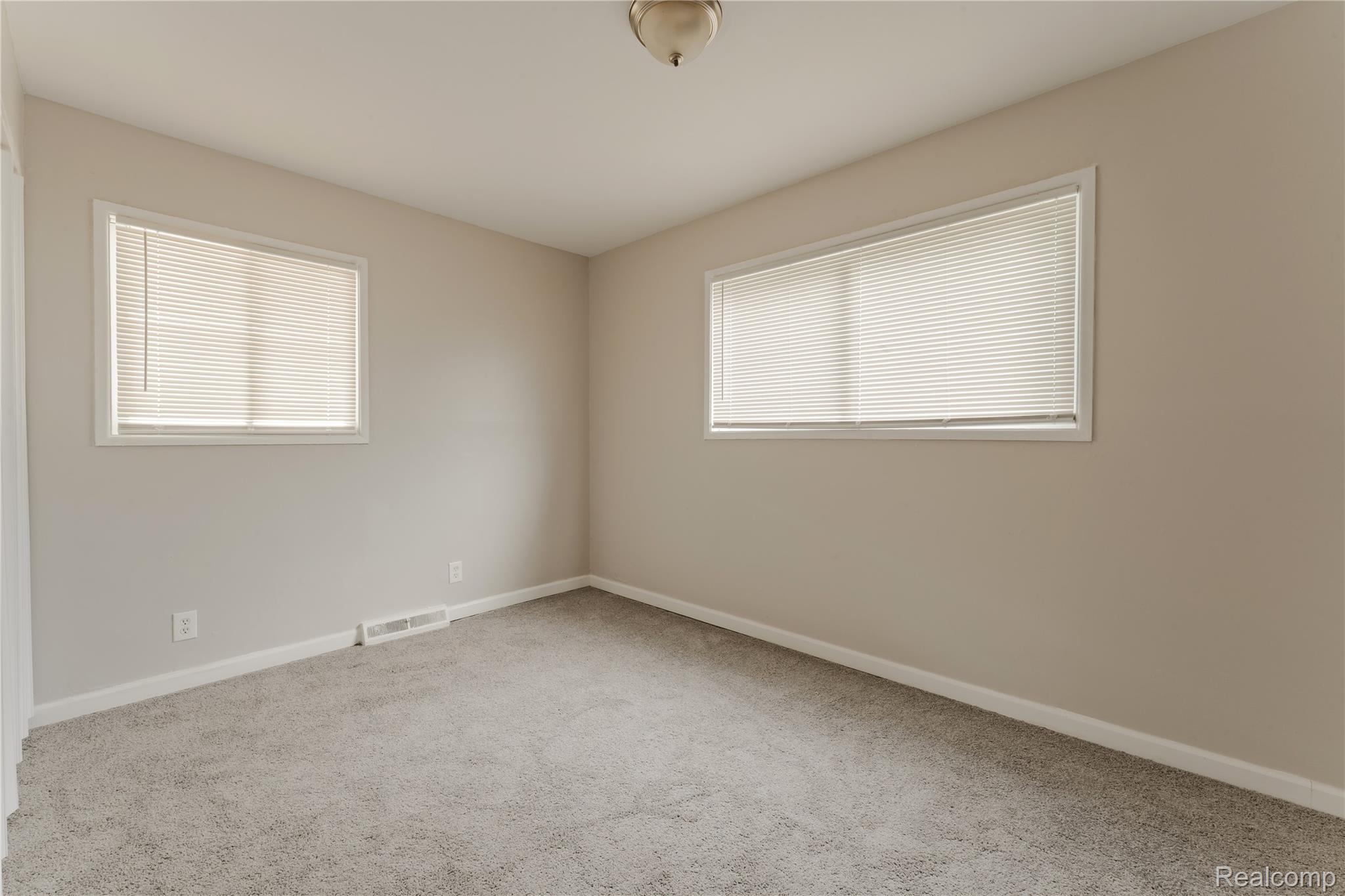 93 West Princeton Avenue Pontiac, MI 48340 - Photo 10 of 31 Neutral-toned walls complement the gray carpeting