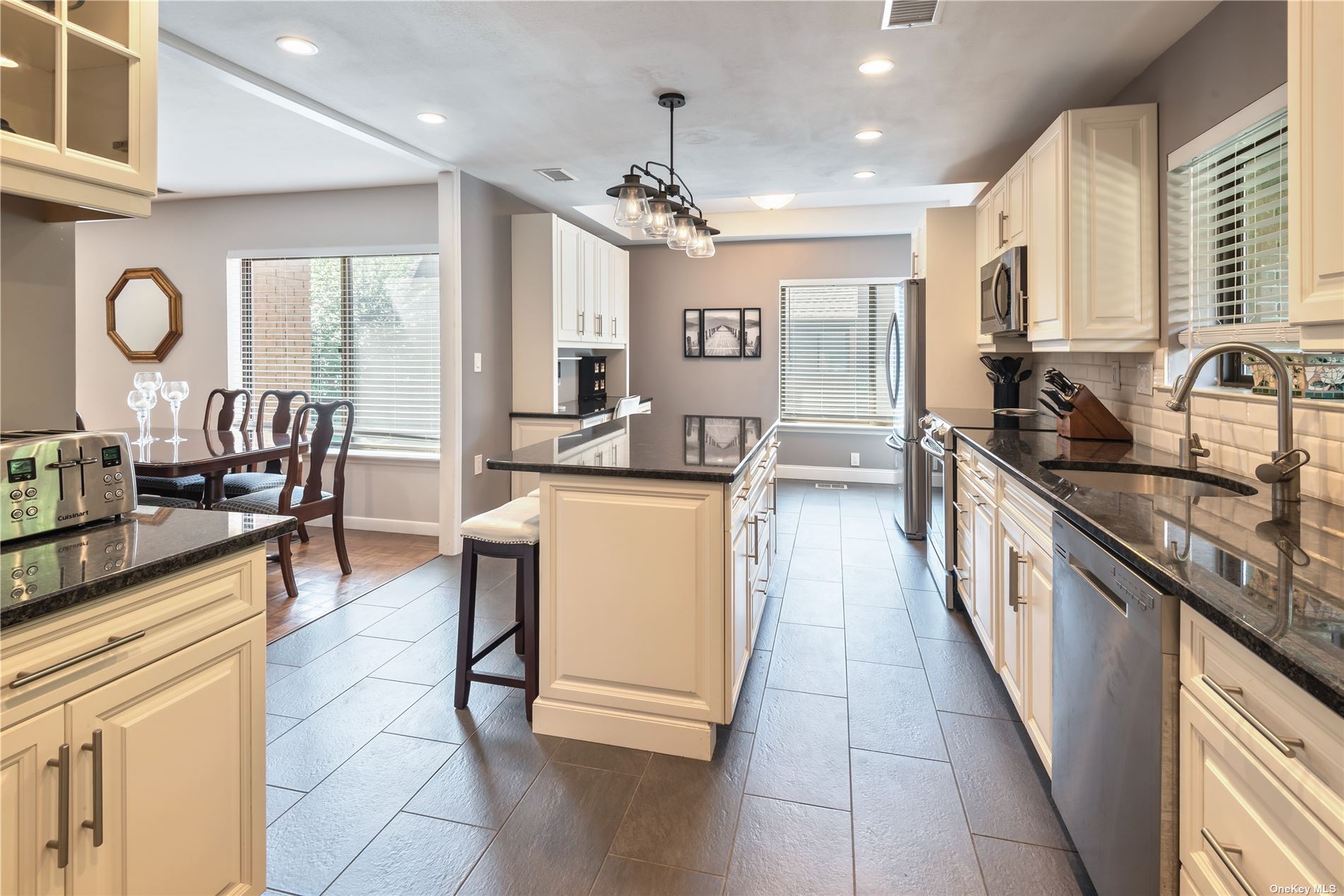 a kitchen with granite countertop lots of counter top space and stainless steel appliances