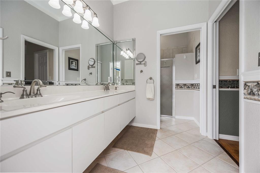 48 Bunker Road Rotonda West, FL 33947 - Photo 29 of 59 a bathroom with a sink a mirror and a shower