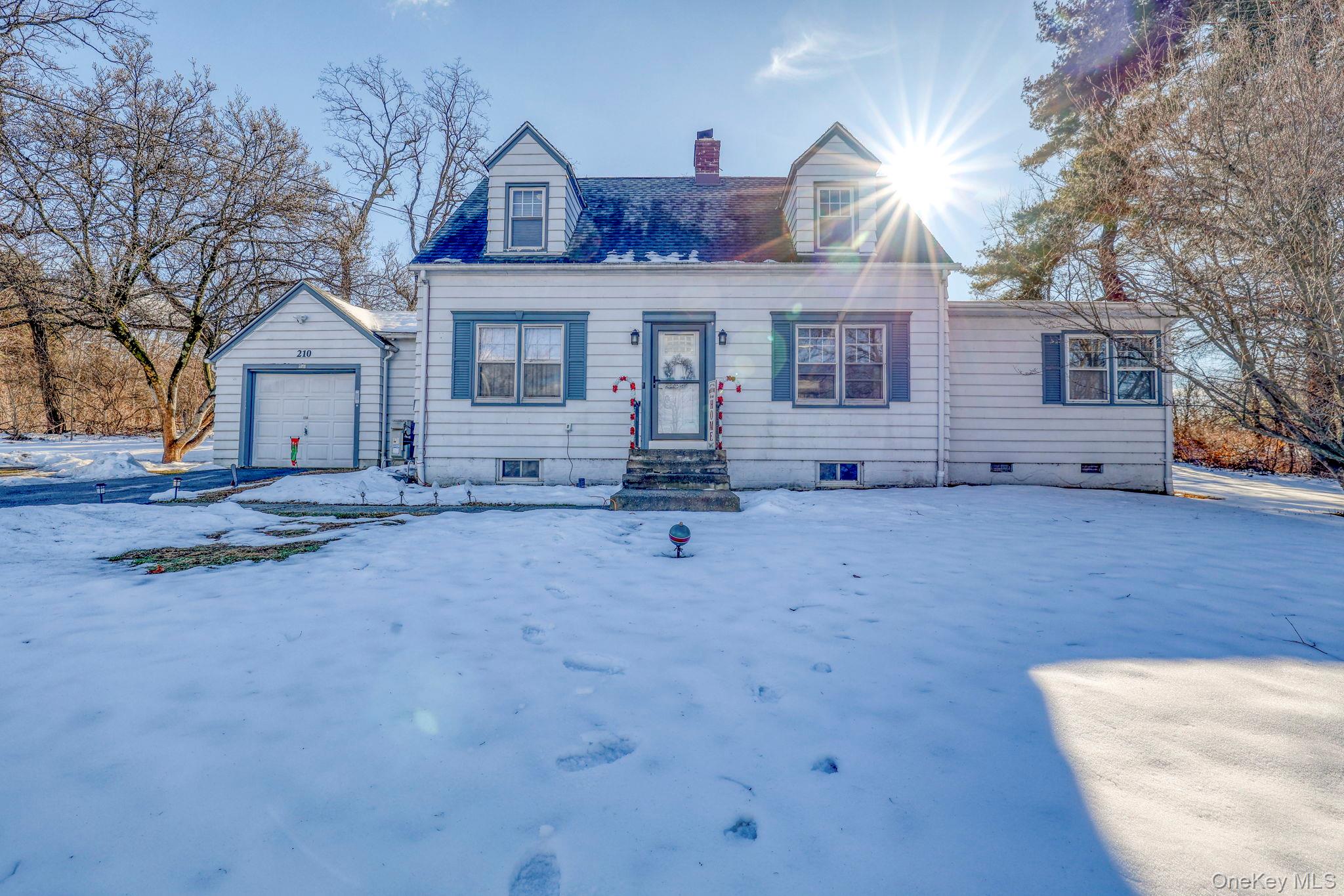 New england style home featuring a chimney