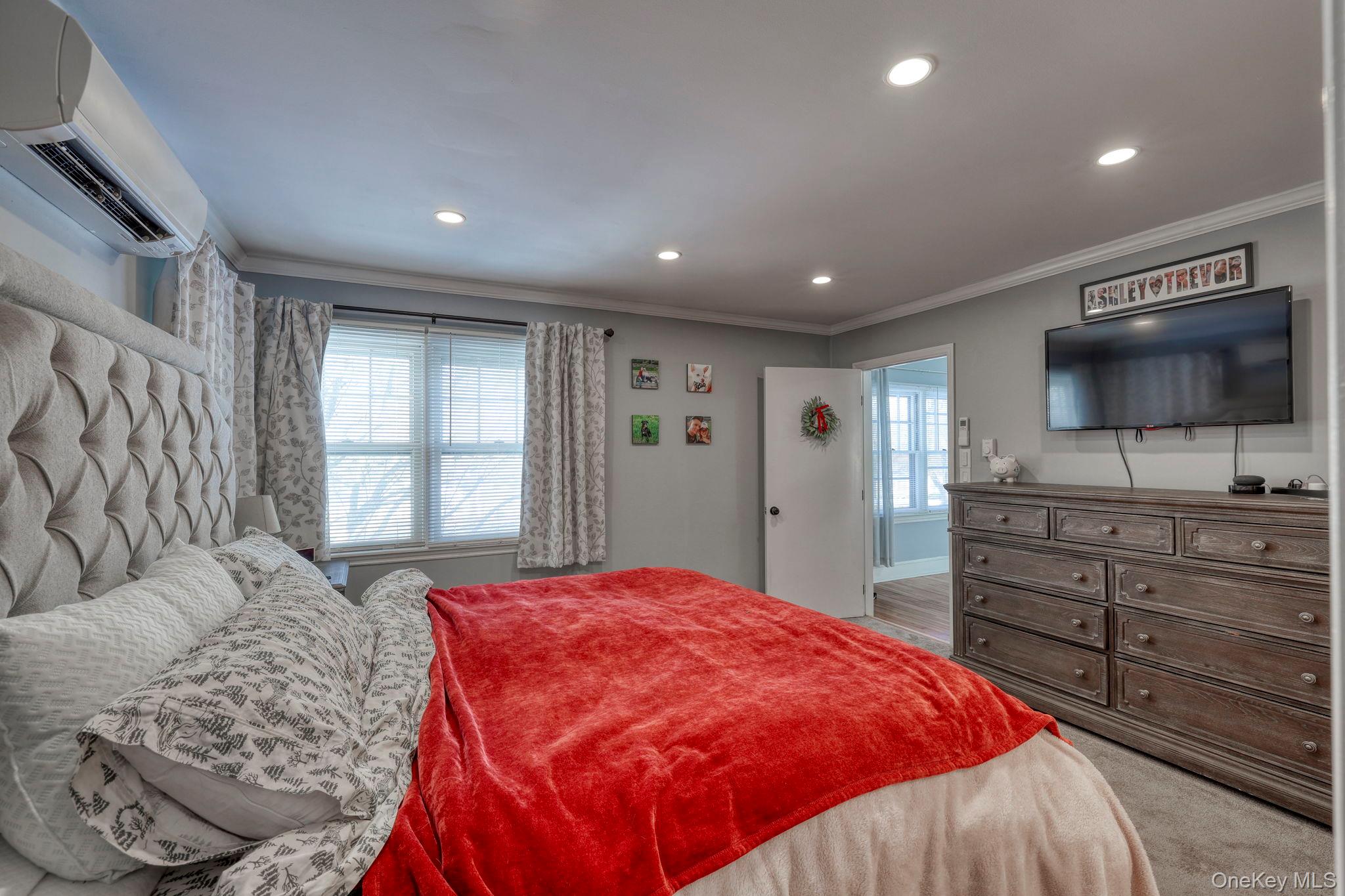 210 Overlook Road Poughkeepsie, NY 12603 - Photo 14 of 43 Bedroom featuring a wall mounted AC, crown molding, multiple windows, light colored carpet, and recessed lighting