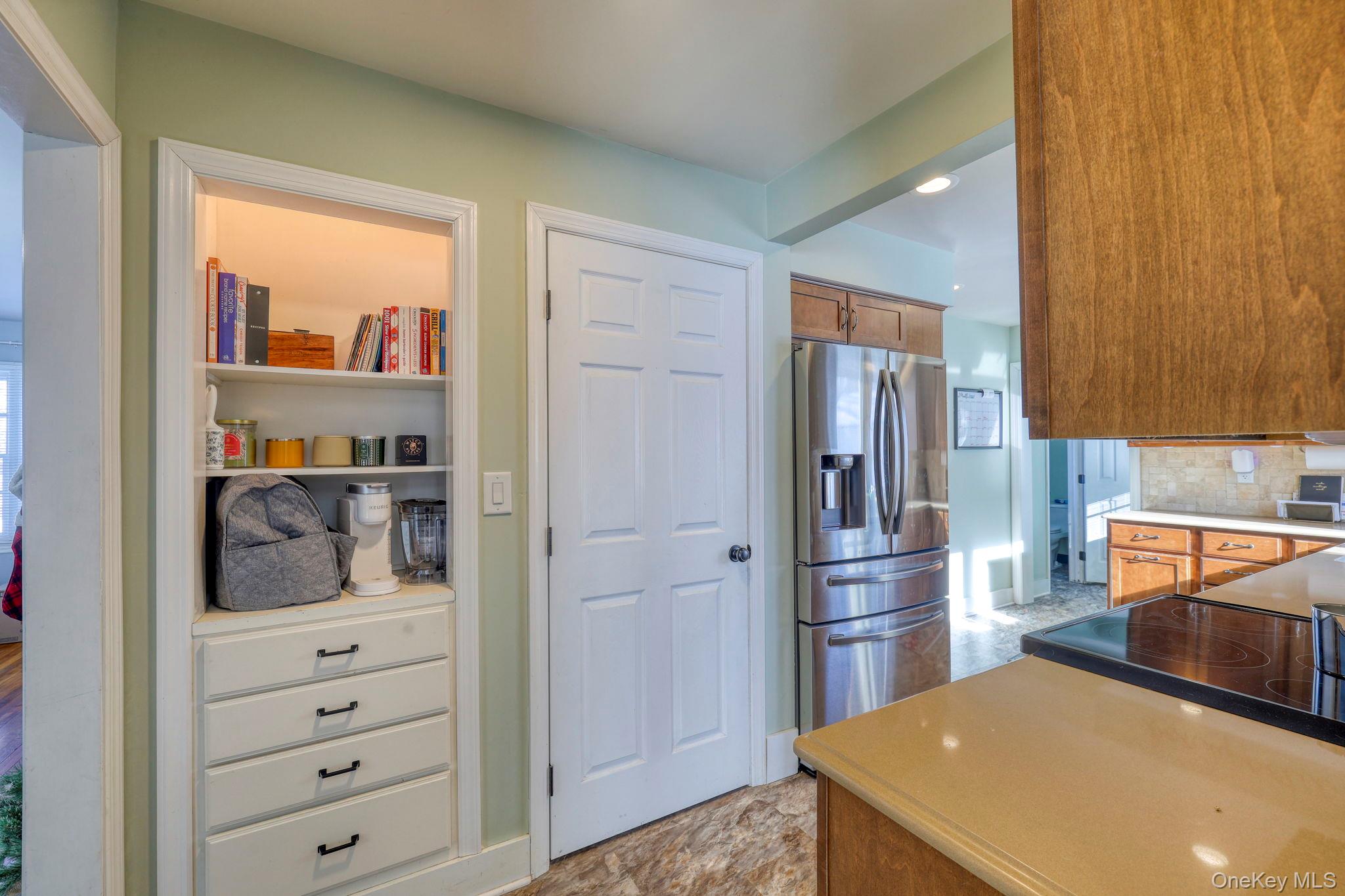 210 Overlook Road Poughkeepsie, NY 12603 - Photo 19 of 43 Kitchen featuring stainless steel refrigerator with ice dispenser, brown cabinetry, light countertops, and tasteful backsplash