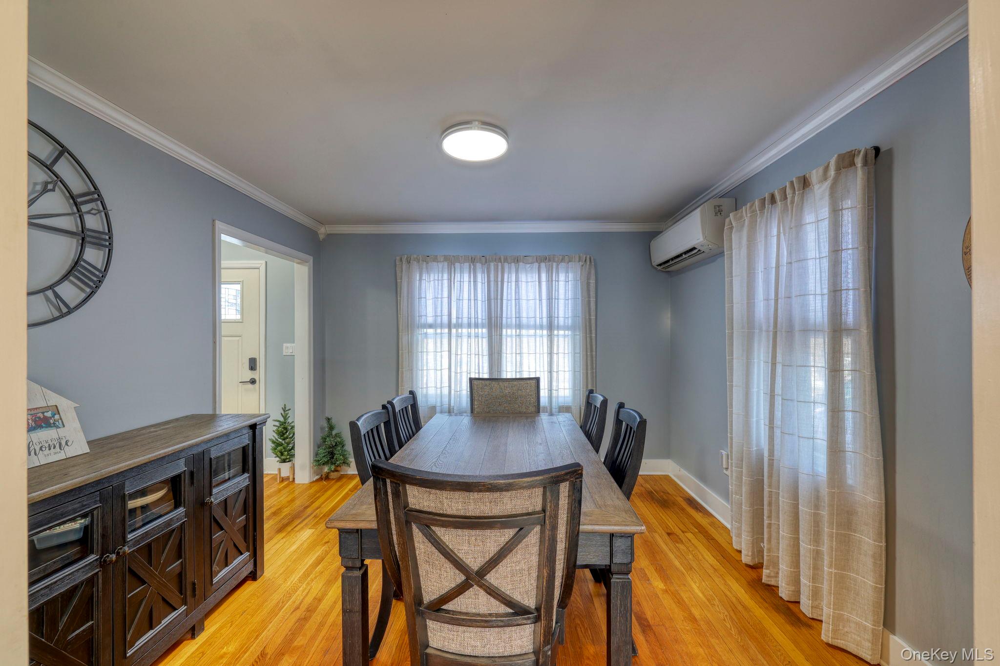 210 Overlook Road Poughkeepsie, NY 12603 - Photo 21 of 43 Dining space with light wood-style floors, crown molding, and a wall unit AC