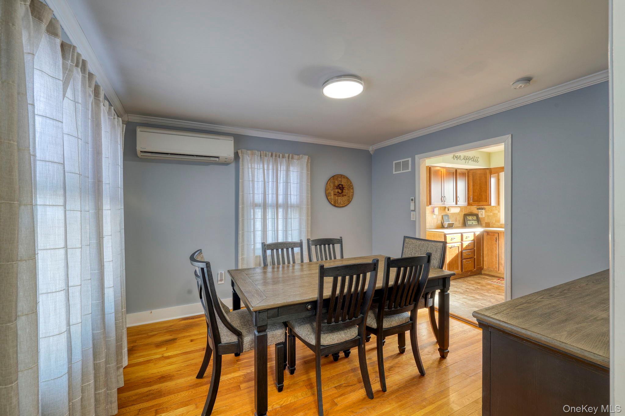 210 Overlook Road Poughkeepsie, NY 12603 - Photo 22 of 43 Dining area with light wood-type flooring, a wall mounted air conditioner, and ornamental molding