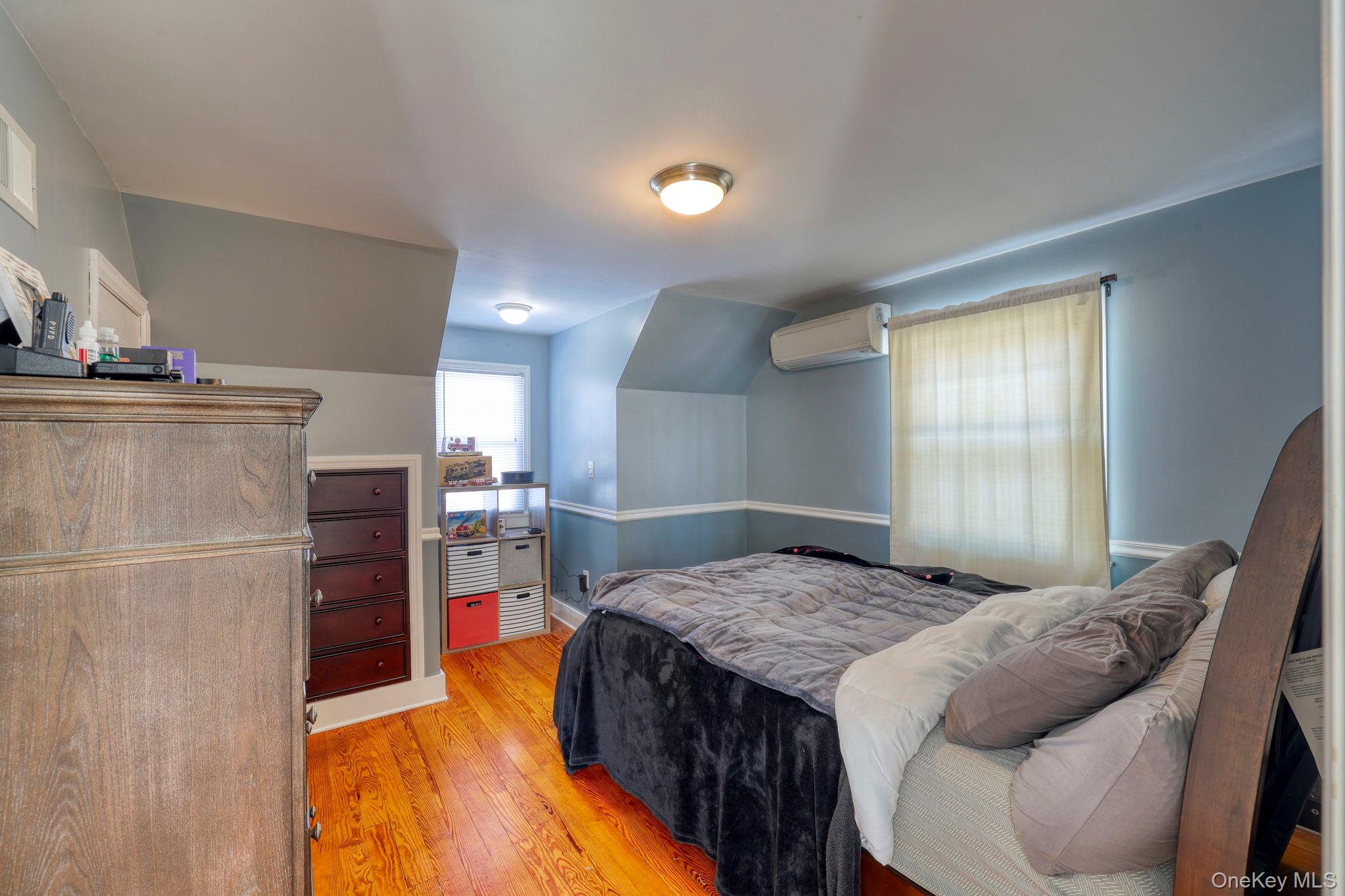 210 Overlook Road Poughkeepsie, NY 12603 - Photo 23 of 43 Bedroom with light wood-style flooring, lofted ceiling, and an AC wall unit