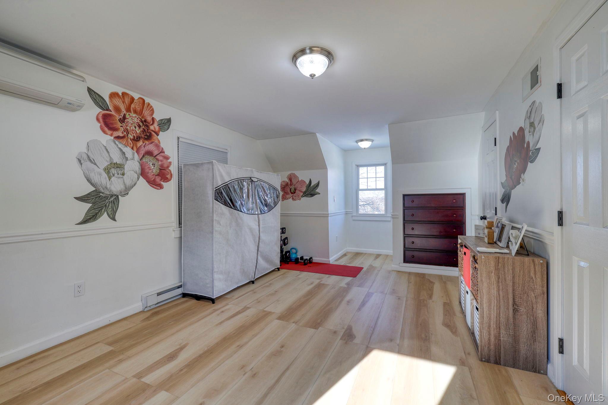 210 Overlook Road Poughkeepsie, NY 12603 - Photo 26 of 43 Foyer entrance featuring light wood-type flooring, a baseboard radiator, and a wall mounted air conditioner