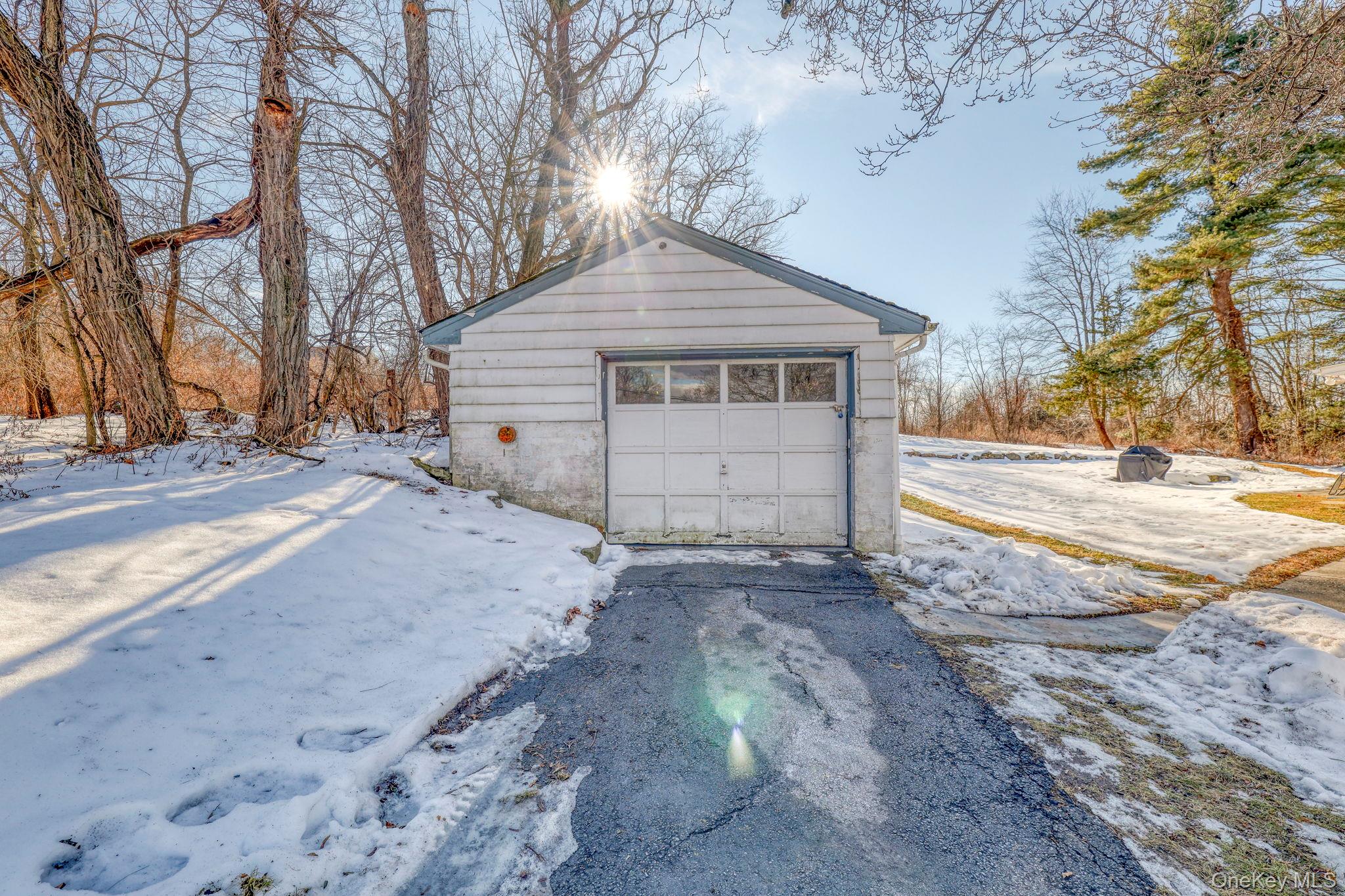 210 Overlook Road Poughkeepsie, NY 12603 - Photo 31 of 43 Snow covered garage featuring a garage and driveway