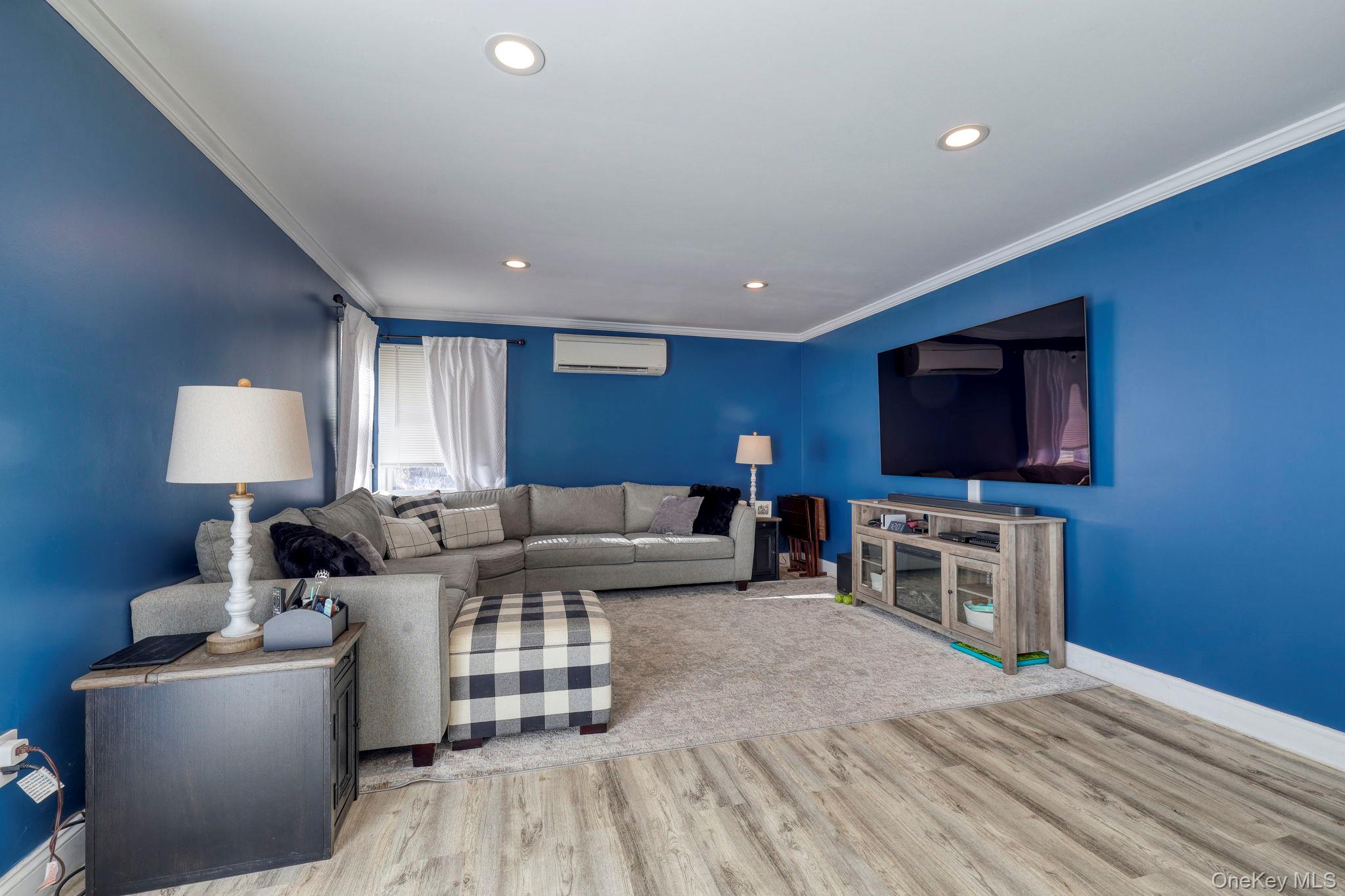 210 Overlook Road Poughkeepsie, NY 12603 - Photo 7 of 43 Living area with ornamental molding, wood finished floors, recessed lighting, and a wall unit AC