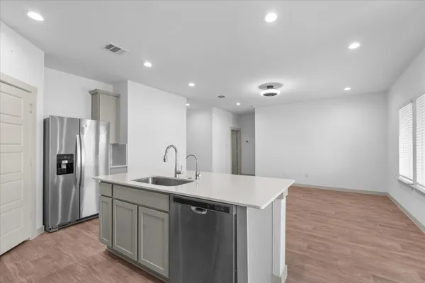 a kitchen with stainless steel appliances a refrigerator sink and stove