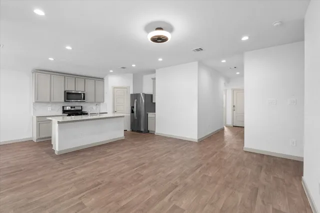 a view of kitchen with refrigerator sink and white cabinets