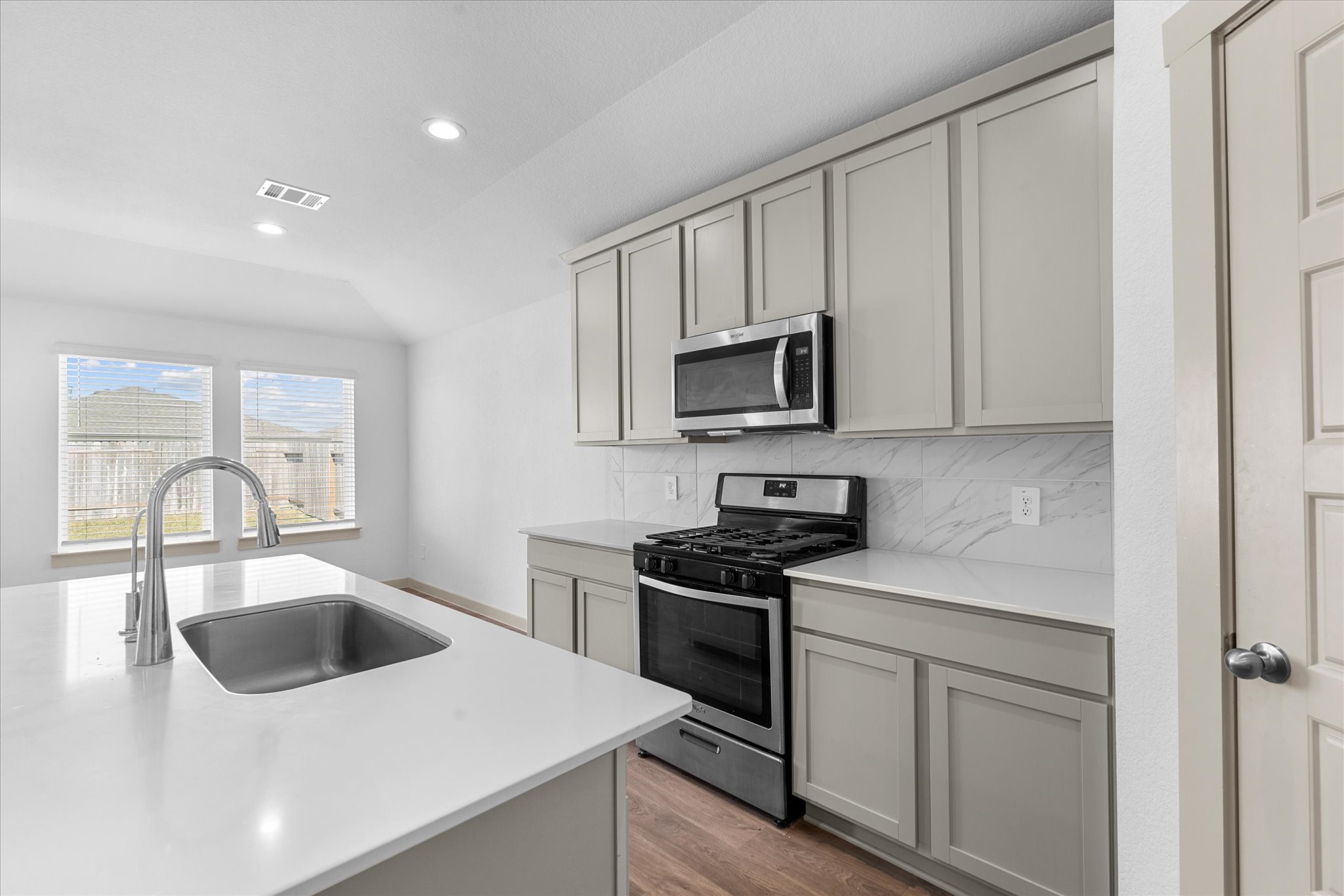 8102 Buck Lane Rosharon, TX 77583 - Photo 10 of 26 a kitchen with white cabinets and appliances