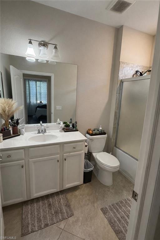 4284 Raffia Palm Circle Naples, FL 34119 - Photo 9 of 50 Full bath featuring vanity, shower / bath combination with glass door, and light tile patterned flooring