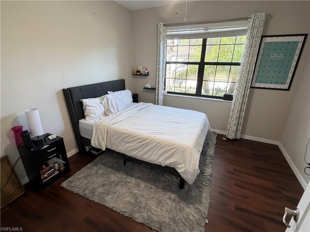 4284 Raffia Palm Circle Naples, FL 34119 - Photo 10 of 50 Bedroom with baseboards and dark wood-style floors