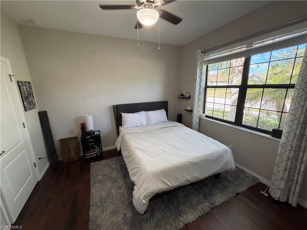4284 Raffia Palm Circle Naples, FL 34119 - Photo 11 of 50 Bedroom featuring dark wood-style floors and ceiling fan