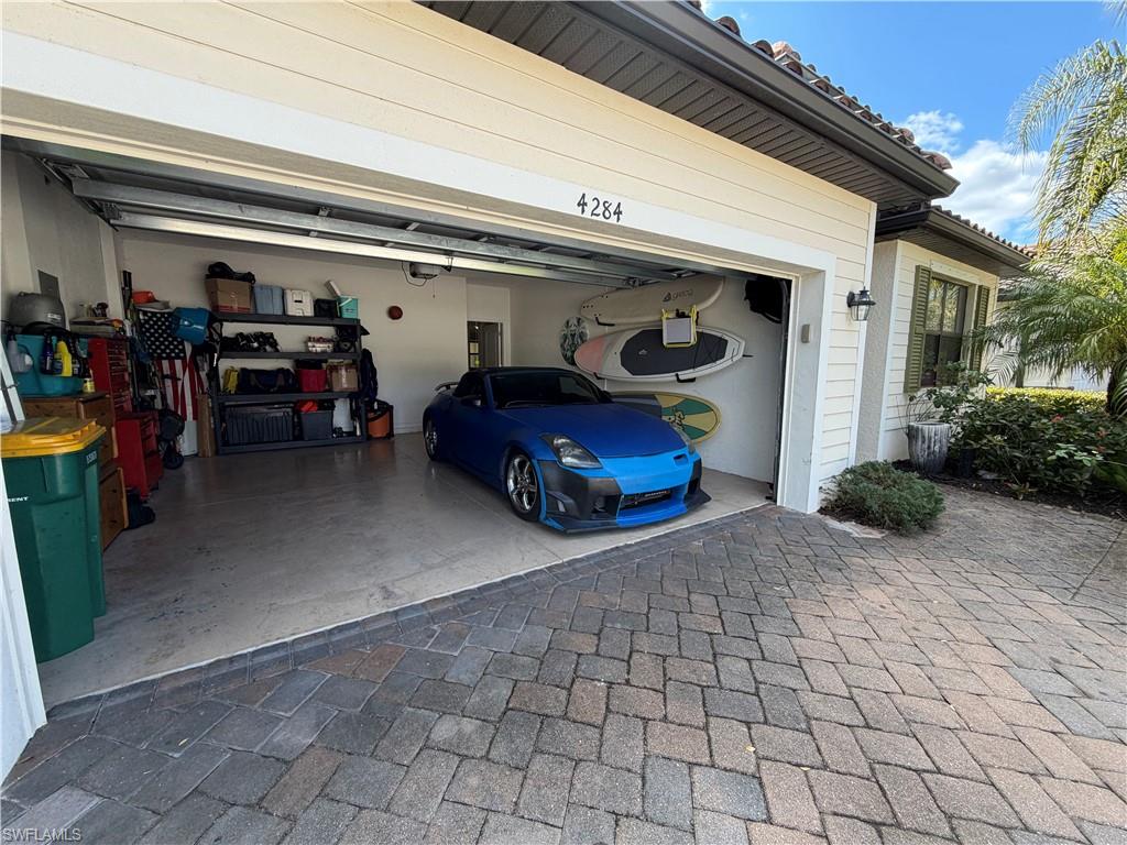 4284 Raffia Palm Circle Naples, FL 34119 - Photo 19 of 50 Garage featuring driveway