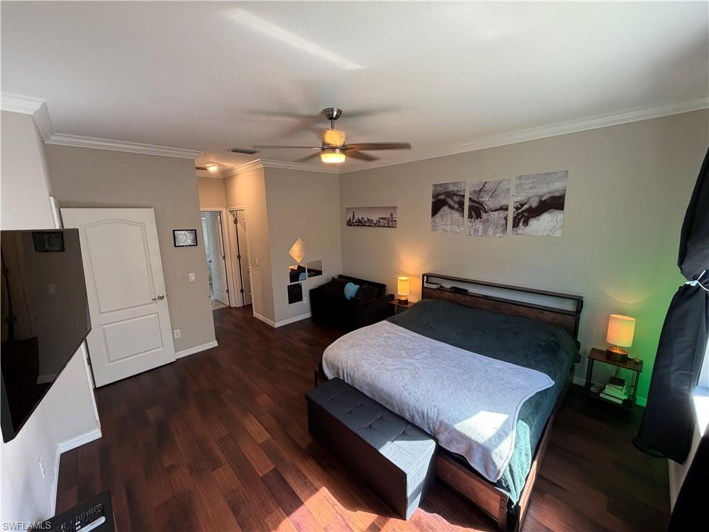 4284 Raffia Palm Circle Naples, FL 34119 - Photo 27 of 50 Master bedroom with ornamental molding, dark wood finished floors, a closet, and ceiling fan