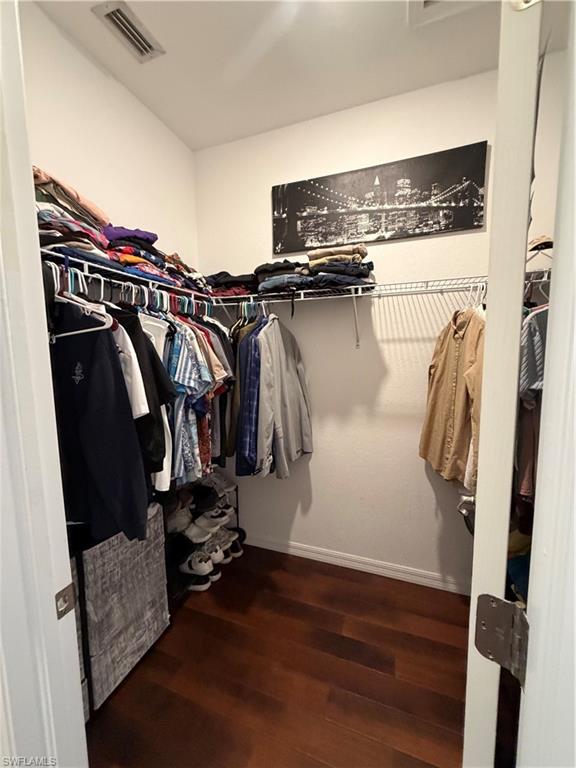 4284 Raffia Palm Circle Naples, FL 34119 - Photo 30 of 50 Walk in closet featuring dark wood-type flooring and attic access