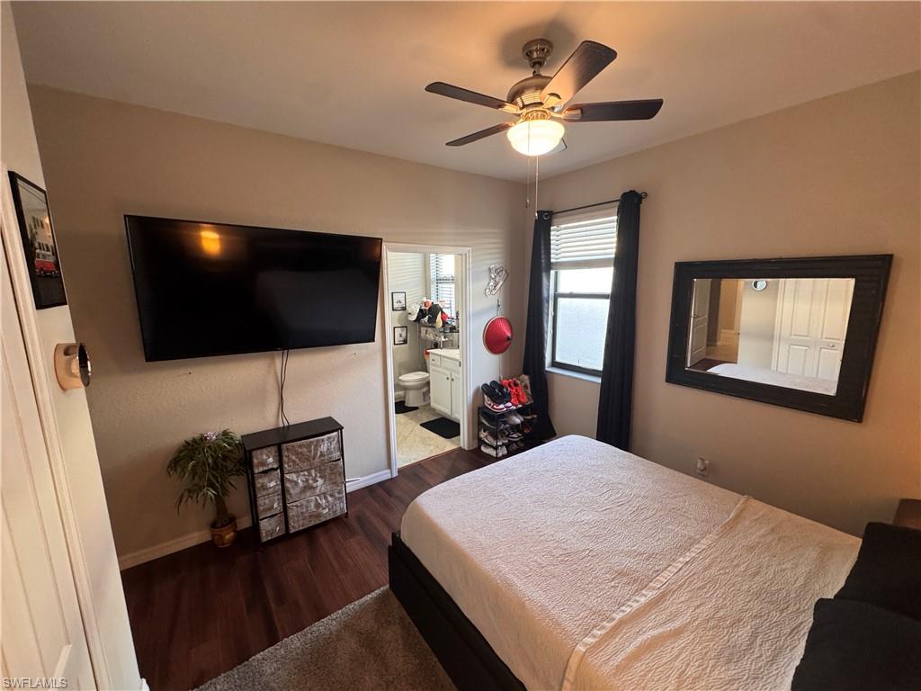 4284 Raffia Palm Circle Naples, FL 34119 - Photo 41 of 50 Bedroom with ensuite bathroom, dark wood finished floors, and a ceiling fan
