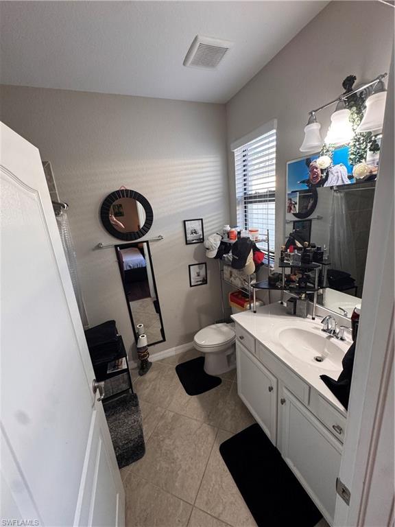 4284 Raffia Palm Circle Naples, FL 34119 - Photo 43 of 50 Bathroom with vanity and light tile patterned floors