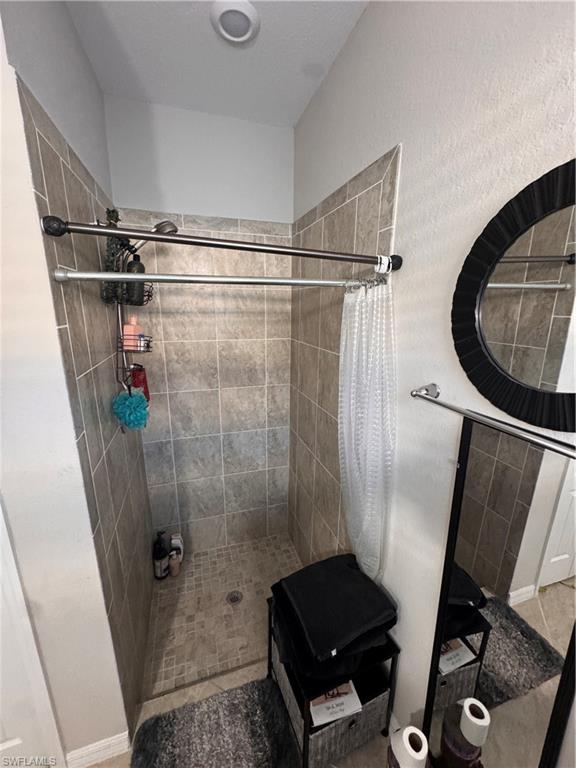 4284 Raffia Palm Circle Naples, FL 34119 - Photo 44 of 50 Full bathroom with a shower stall and baseboards