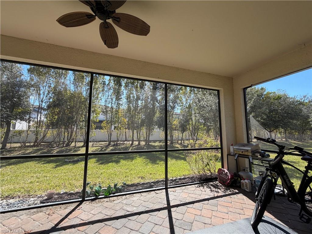 4284 Raffia Palm Circle Naples, FL 34119 - Photo 46 of 50 Sunroom / solarium featuring a ceiling fan