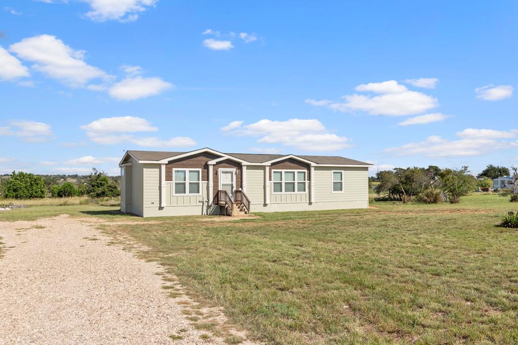 192 Chuckwagon Trail Harper, TX 78631 - Photo 14 of 23 a view of an house with backyard and road