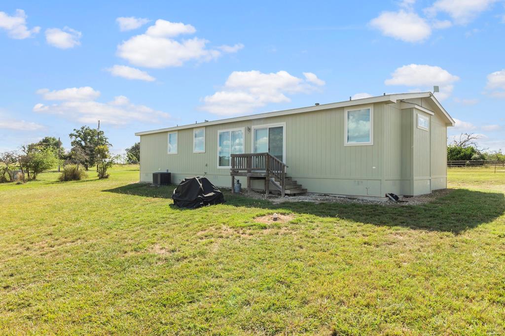 192 Chuckwagon Trail Harper, TX 78631 - Photo 17 of 23 a view of a house with backyard and sitting area