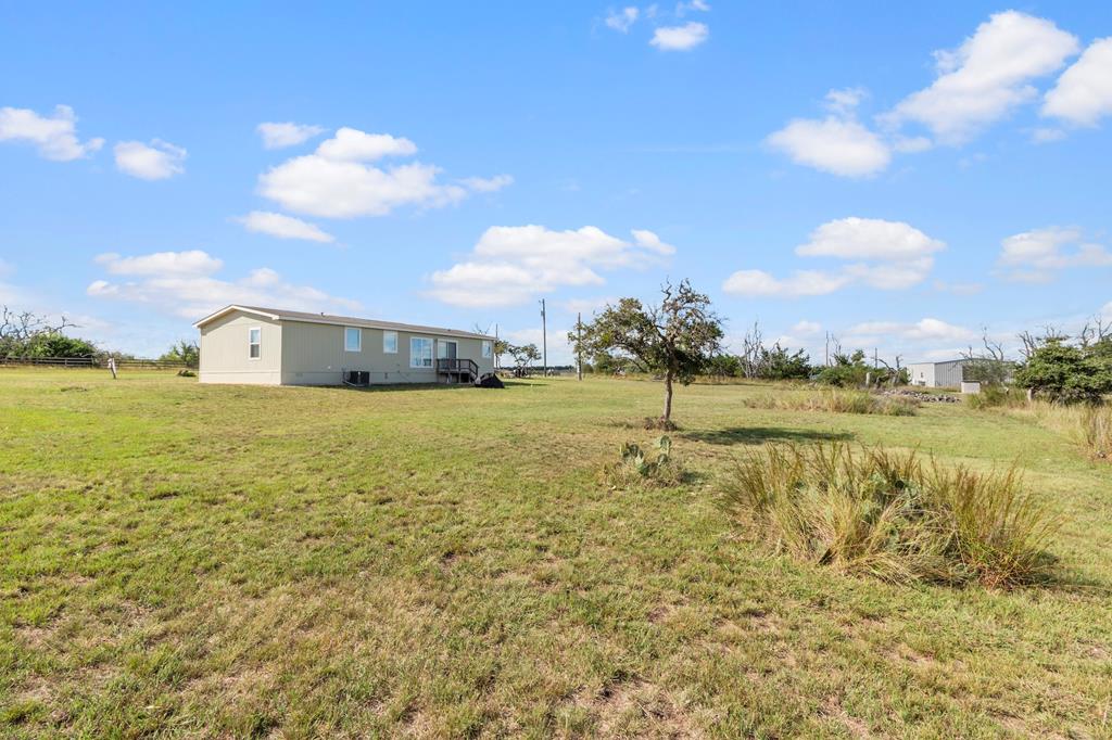 192 Chuckwagon Trail Harper, TX 78631 - Photo 19 of 23 a view of a large body of water with a building in the background