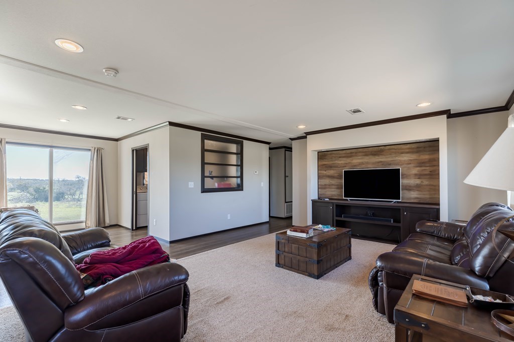 192 Chuckwagon Trail Harper, TX 78631 - Photo 2 of 23 a living room with furniture and a flat screen tv