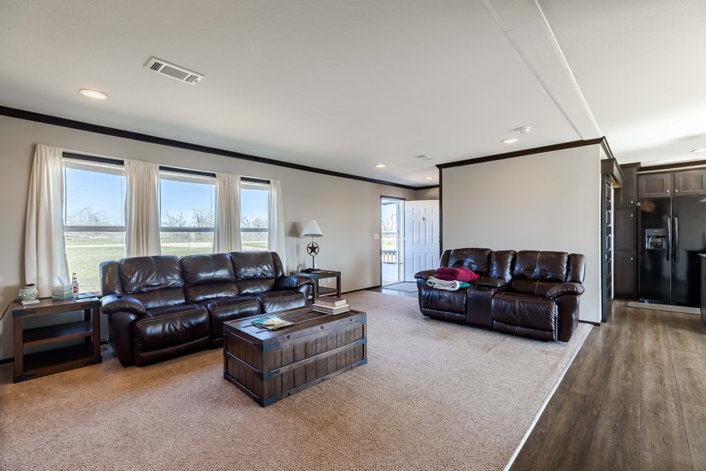 192 Chuckwagon Trail Harper, TX 78631 - Photo 9 of 23 a living room with furniture and a flat screen tv