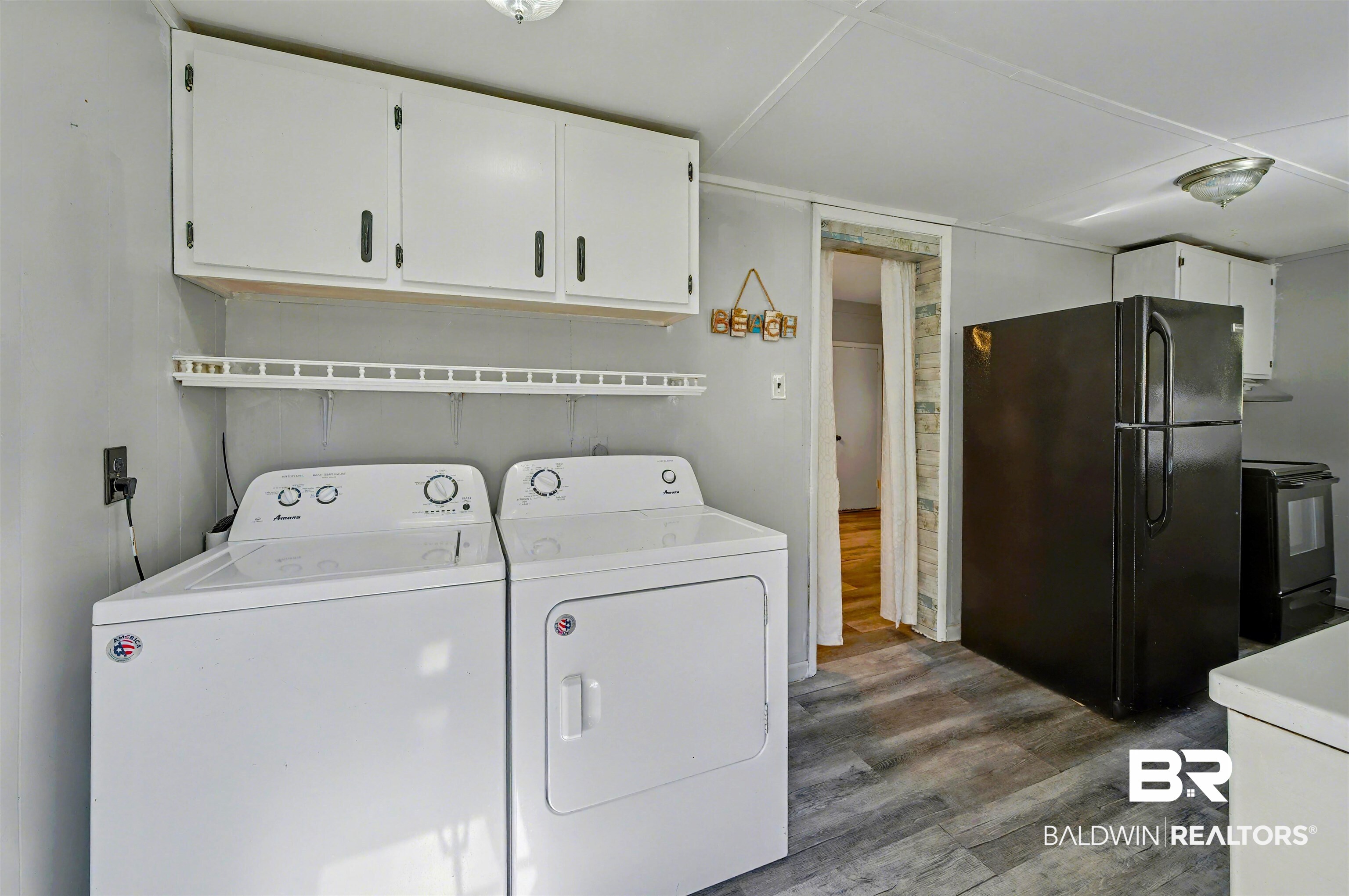 209 West Magnolia Avenue Foley, AL 36535 - Photo 23 of 23 Laundry room with wood finished floors and separate washer and dryer