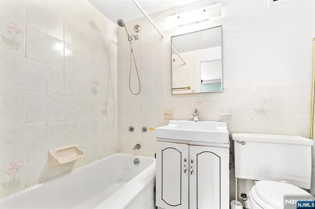 a bathroom with a sink a toilet and a bathtub