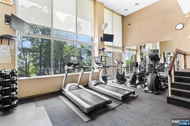a living room with lots of furniture and a floor to ceiling window