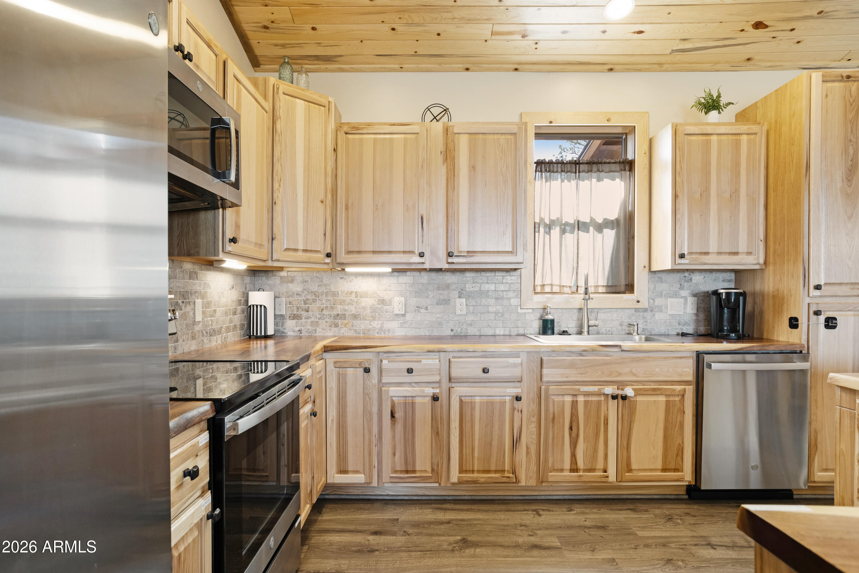 2718 Church Lane Overgaard, AZ 85933 - Photo 16 of 50 a kitchen with stainless steel appliances granite countertop a stove a sink and a microwave