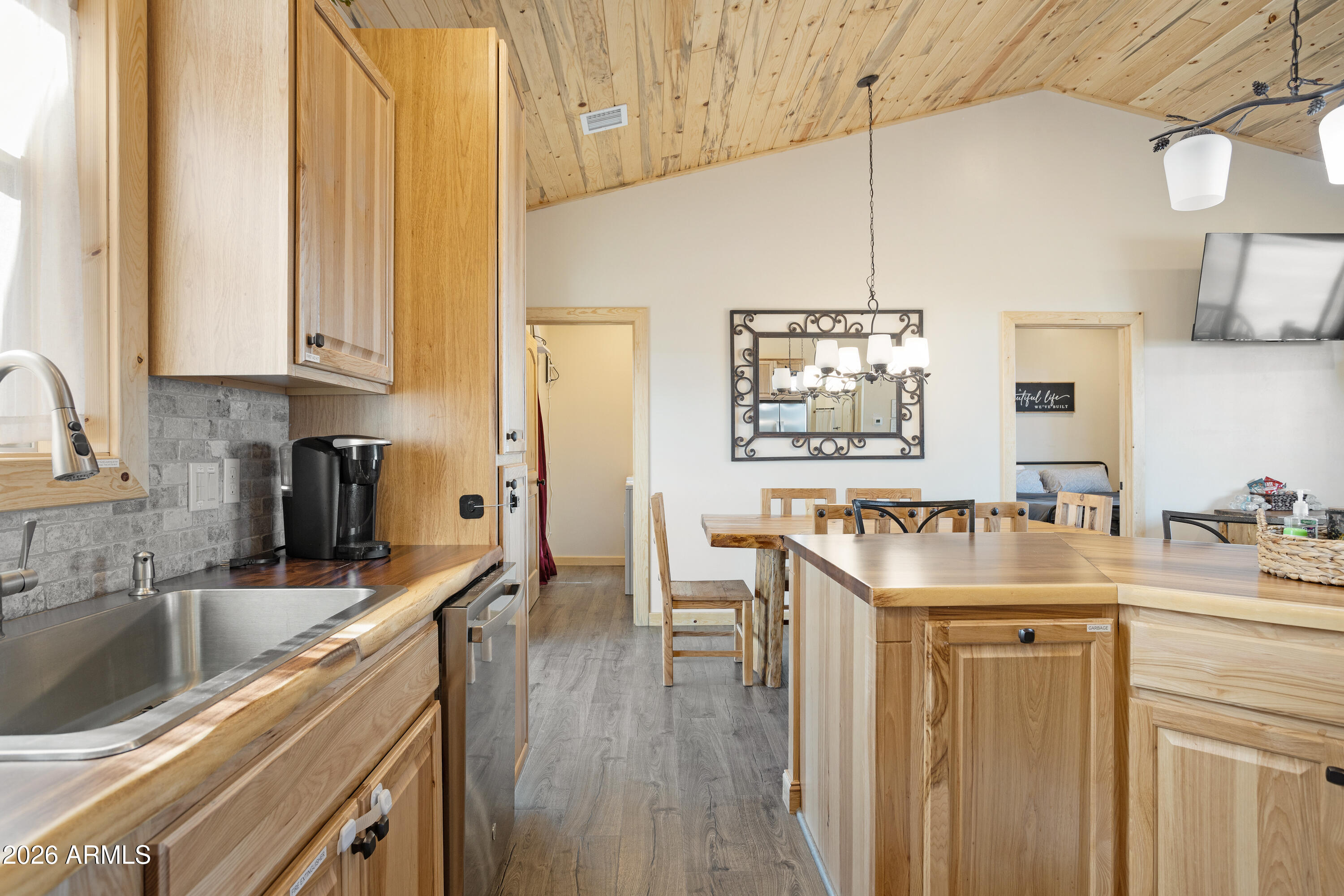 2718 Church Lane Overgaard, AZ 85933 - Photo 17 of 50 a kitchen with stainless steel appliances granite countertop a sink a stove and a wooden cabinets